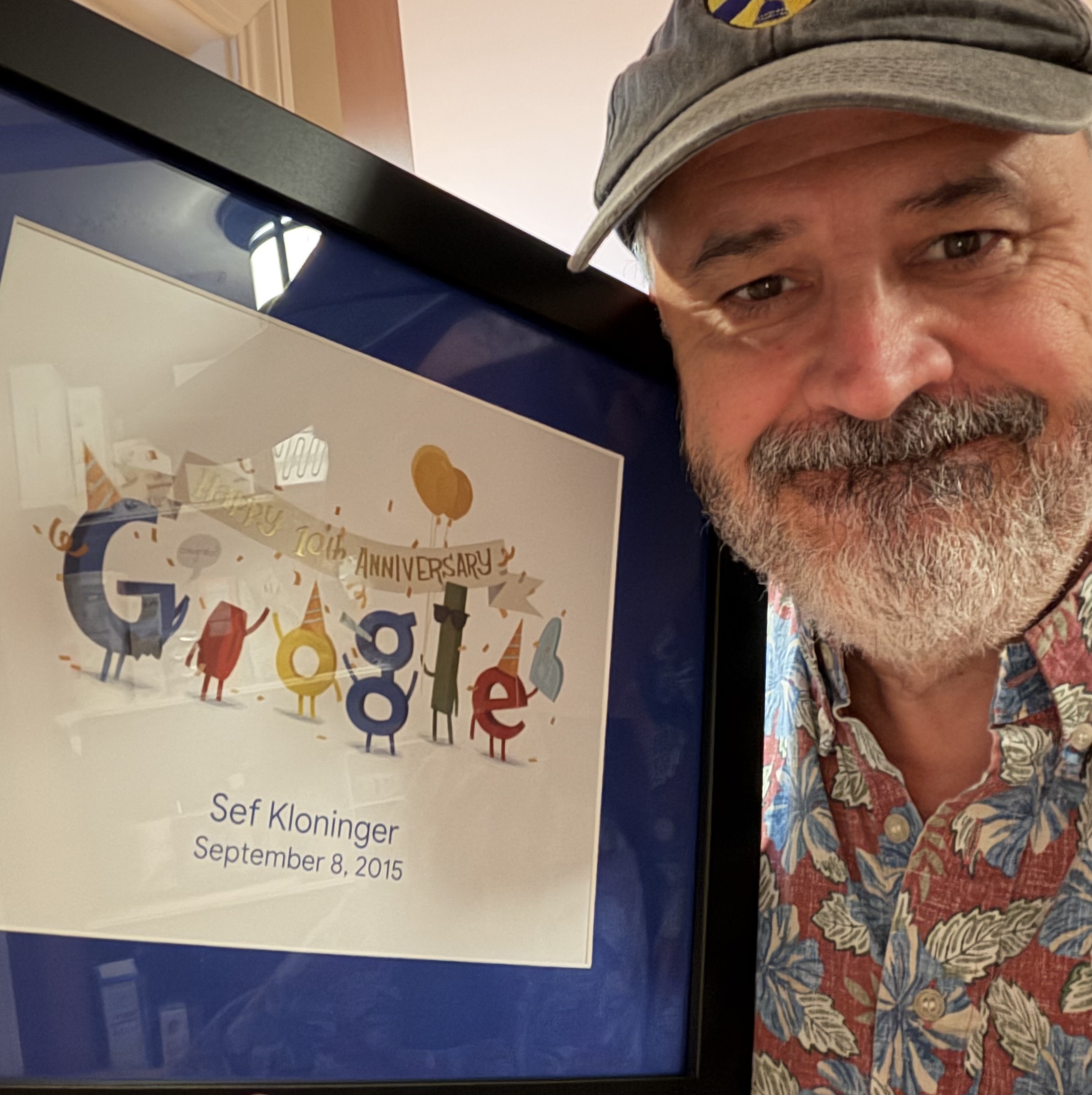Sef holding a framed certificate, Google ten years of service.